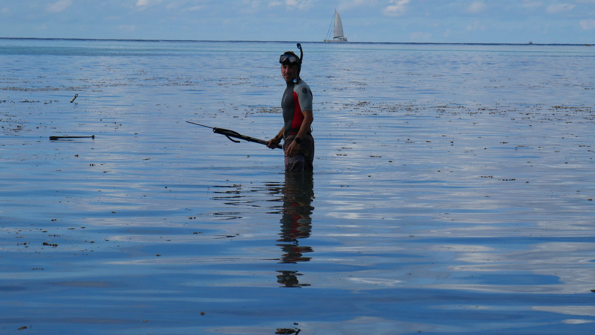Spearfisherman in the lagoon, Moorea, French Polynesia